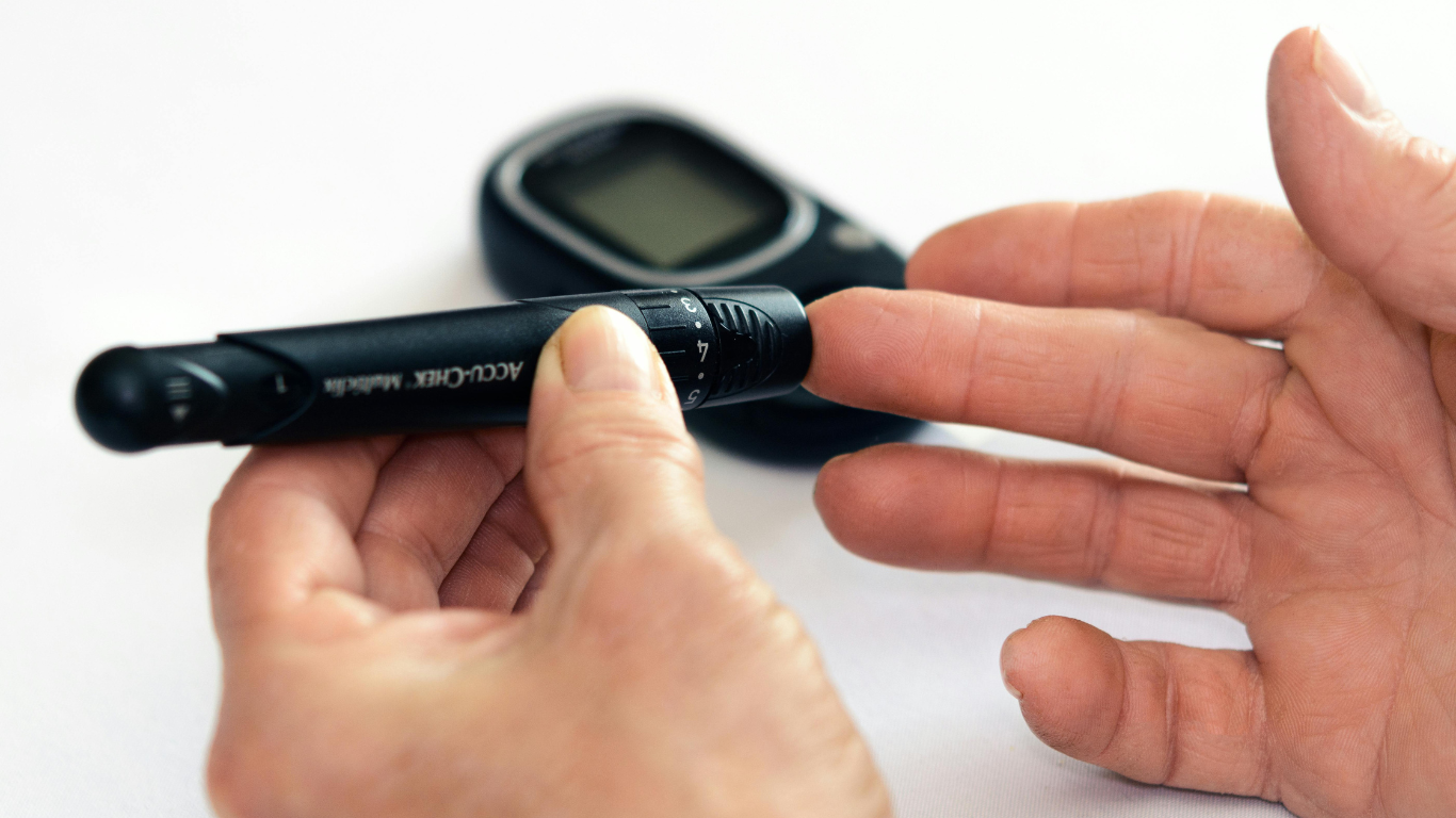 Close-up of a hand holding an insulin syringe for injection, demonstrating a diabetes management technique